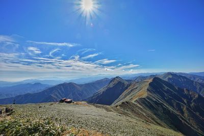 Scenic view of mountains against blue sky