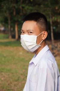 Portrait of man wearing mask standing on field