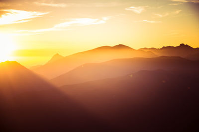 Scenic view of silhouette mountains against sky during sunset