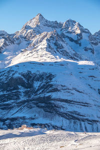 Scenic view of mountains against blue sky