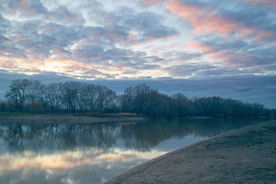 Scenic view of lake against cloudy sky