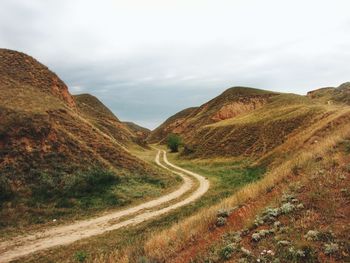 Scenic view of mountain road against sky