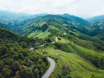 High angle view of green landscape against sky