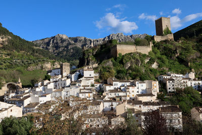 Buildings in town against sky