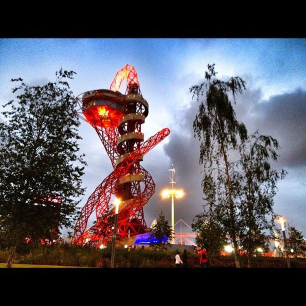 illuminated, transfer print, sky, amusement park, amusement park ride, arts culture and entertainment, night, built structure, auto post production filter, architecture, dusk, city, tree, ferris wheel, travel destinations, building exterior, large group of people, low angle view, capital cities, lighting equipment