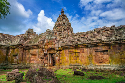 Old temple building against cloudy sky