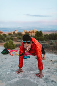 Female camper does pushups at dusk before bedtime camping in utah