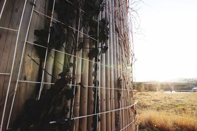 Barbed wire fence against clear sky