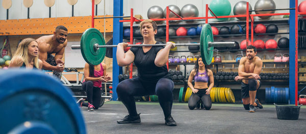 Full length of woman weightlifting at gym