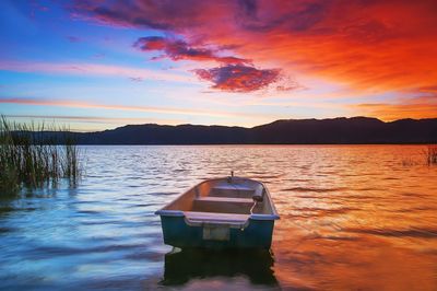 Scenic view of lake against romantic sky at sunset