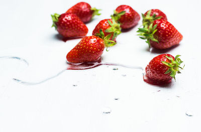 High angle view of strawberries on table against white background
