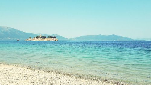 Scenic view of sea against clear blue sky