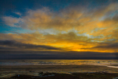 Scenic view of dramatic sky over sea during sunset