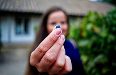 Close-up of person hand on purple house