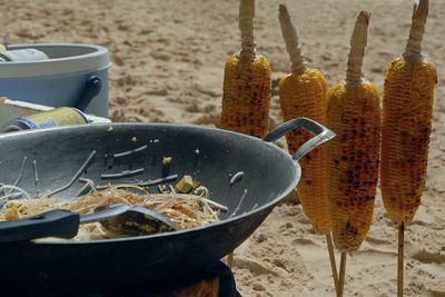 Close-up of food on sand at beach