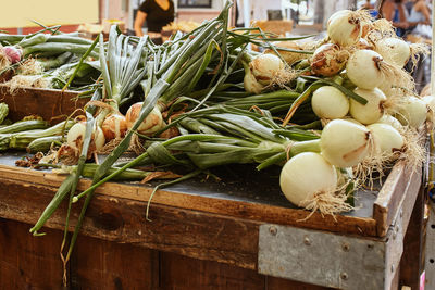 Pile of local grown white onions on sale at a farmers market in boulder, colorado. allium cepa