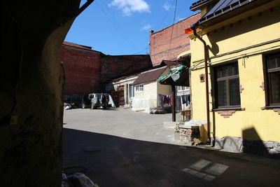 Street amidst buildings in town against sky