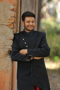 Portrait of young man standing outdoors