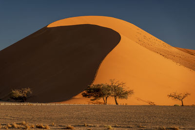 Scenic view of desert against clear sky