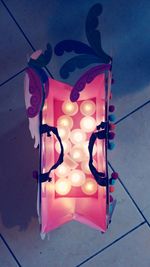 Close-up of illuminated lighting equipment hanging on wall