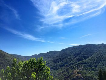 Scenic view of mountains against blue sky