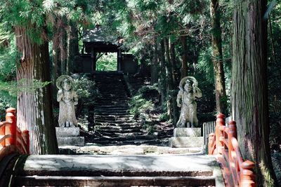 Statue against trees