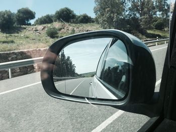 Reflection of car on side-view mirror