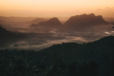 Scenic view of silhouette mountains against sky at sunset