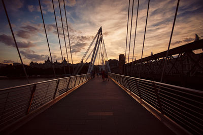 Suspension bridge against sky during sunset