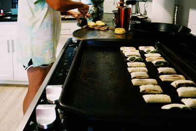 Midsection of man preparing food in kitchen