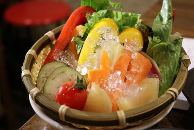 High angle view of sliced vegetables with crushed ice in container