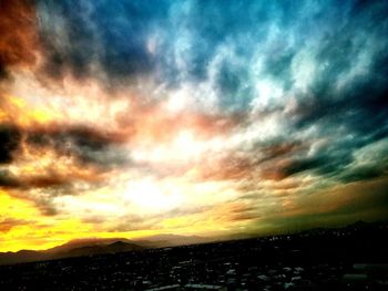 Scenic view of dramatic sky over city