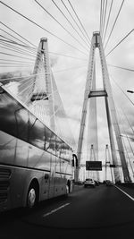 Low angle view of suspension bridge against sky