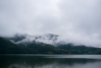 Scenic view of lake against cloudy sky