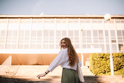 Woman standing against the wall