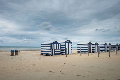 Lifeguard hut on beach against sky