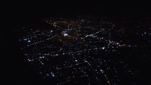 High angle view of illuminated buildings in city at night