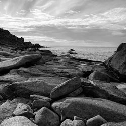 Rocks on beach against sky