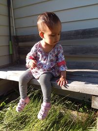 Cute girl sitting on bench