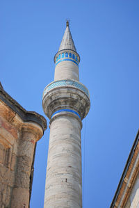 Low angle view of historic building against blue sky