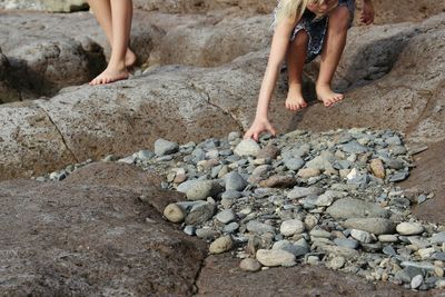 Low section of person standing on pebbles