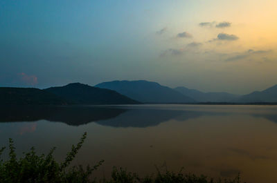 Scenic view of lake against sky during sunset