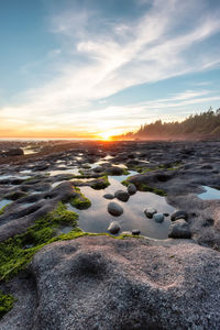 Scenic view of rocks against sky during sunset