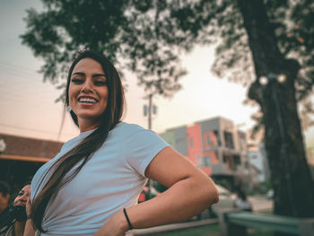 Portrait of smiling young woman in downtown 