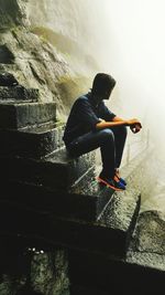 Full length of man sitting on steps