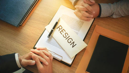 Midsection of person holding text on table