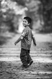 Portrait of boy walking on field