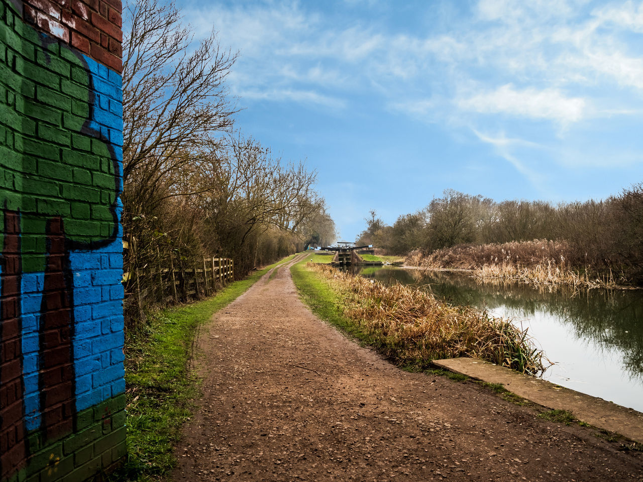 VIEW OF EMPTY ROAD ALONG CANAL