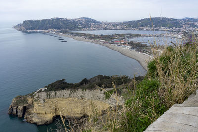 High angle view of sea and buildings against sky