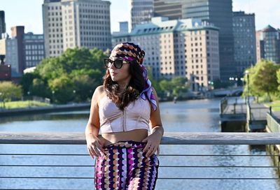 Portrait of smiling young woman standing in city